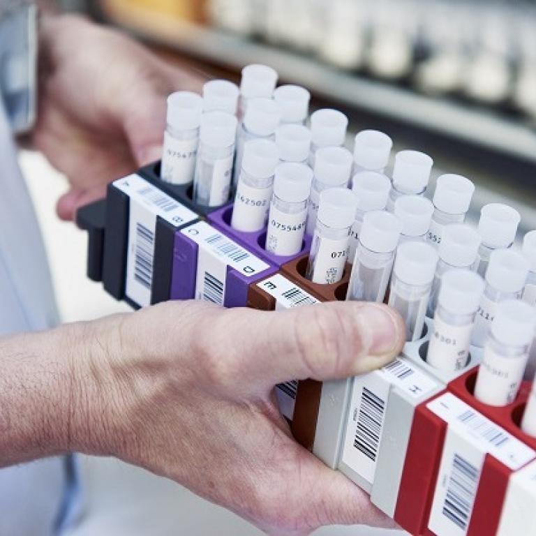 A man holds a box of samples