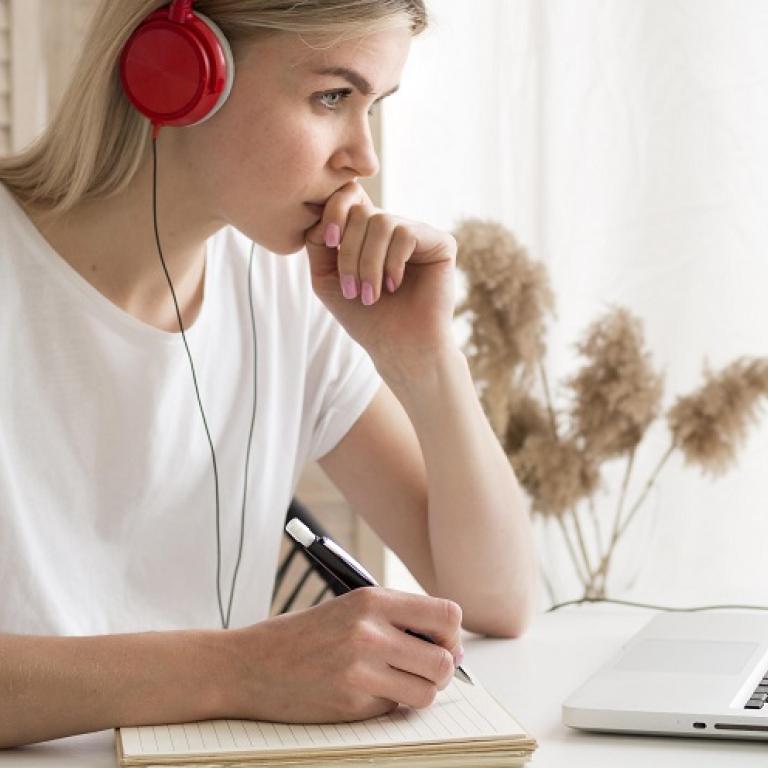 Studente die aan haar laptop een online examen aflegt